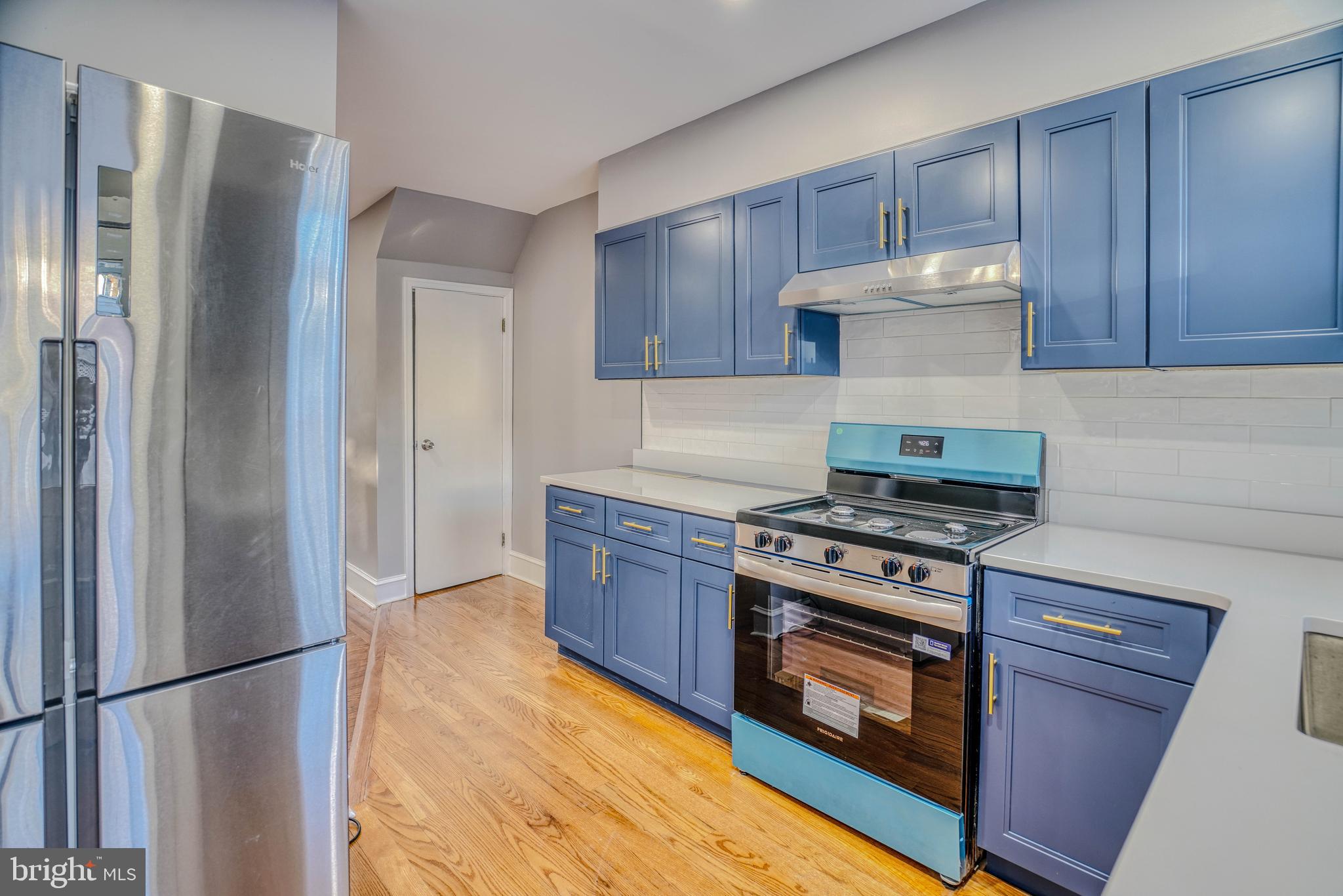 2135 Granite Street Philadelphia, PA 19124 - Photo 13 of 34 a kitchen with a stove and a refrigerator