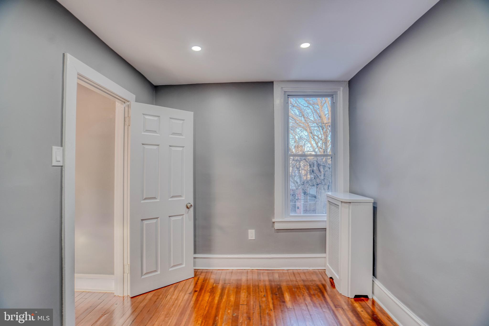 2135 Granite Street Philadelphia, PA 19124 - Photo 24 of 34 a view of an empty room with wooden floor and a window
