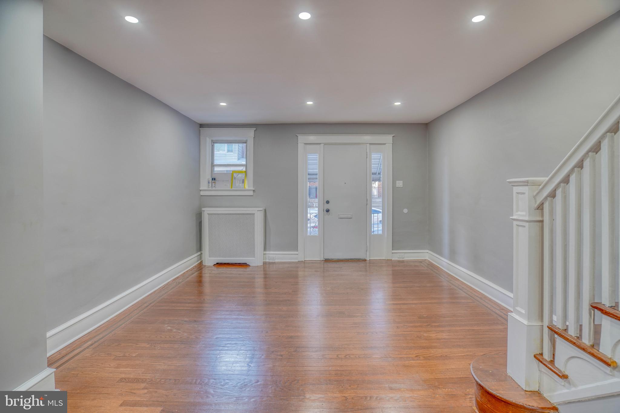 2135 Granite Street Philadelphia, PA 19124 - Photo 7 of 34 a view of an empty room with wooden floor and a window