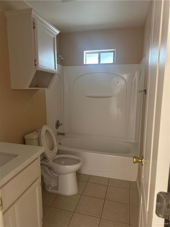 1213 Prosperity Drive, Unit D Edinburg, TX 78541 - Photo 6 of 10 a bathroom with a granite countertop toilet and a sink
