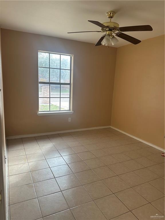 1213 Prosperity Drive, Unit D Edinburg, TX 78541 - Photo 7 of 10 an empty room with windows and fan