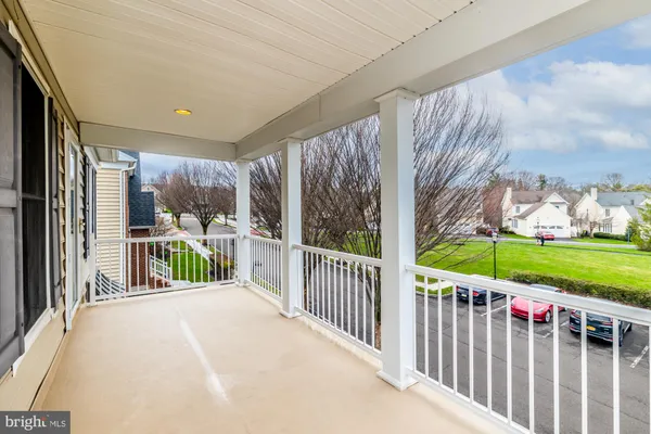 a view of a porch with wooden floor and fence