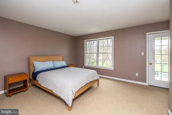 a bed sitting in a room next to a window