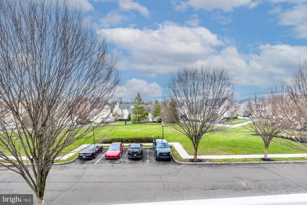 a view of a park with iron fence