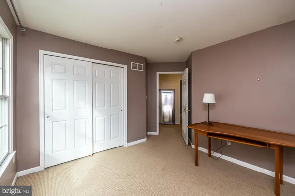 a room with pool table and windows