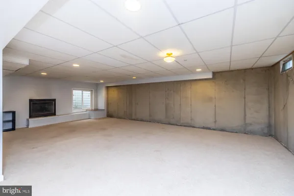 a view of an empty room with a fireplace