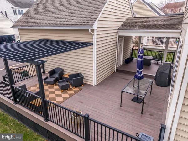 a view of a deck with chairs and wooden floor