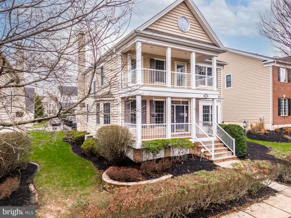 a front view of a house with a yard and outdoor seating