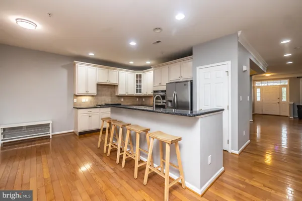 a kitchen with stainless steel appliances granite countertop a refrigerator a stove top oven a sink and dishwasher
