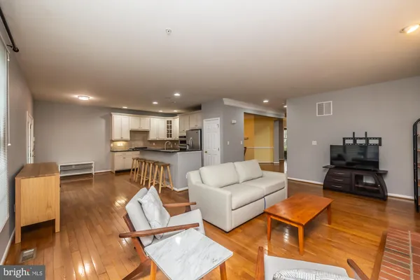 a living room with furniture and kitchen view