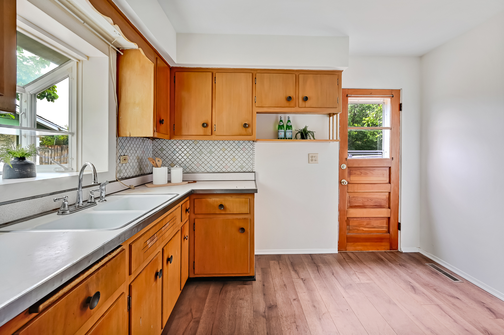 1018 Rolling Drive Lisle, IL 60532 - Photo 11 of 17 a kitchen with wooden floors and sink