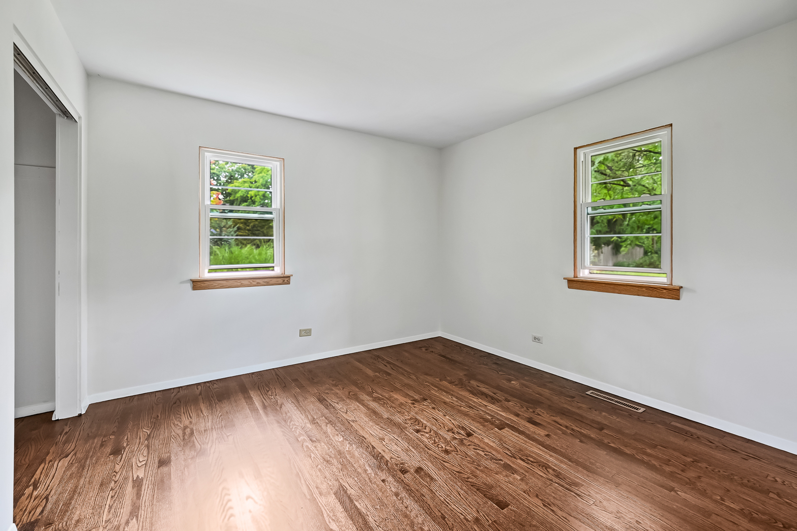 1018 Rolling Drive Lisle, IL 60532 - Photo 14 of 17 a view of an empty room with wooden floor and a window