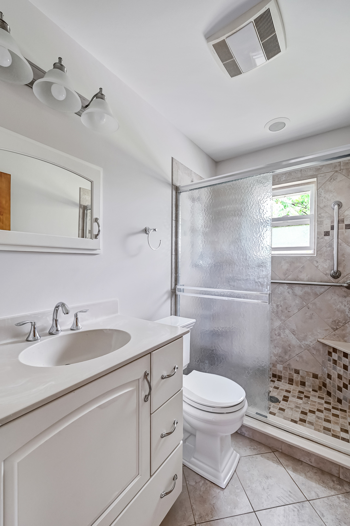 1018 Rolling Drive Lisle, IL 60532 - Photo 15 of 17 a bathroom with a sink a toilet and shower