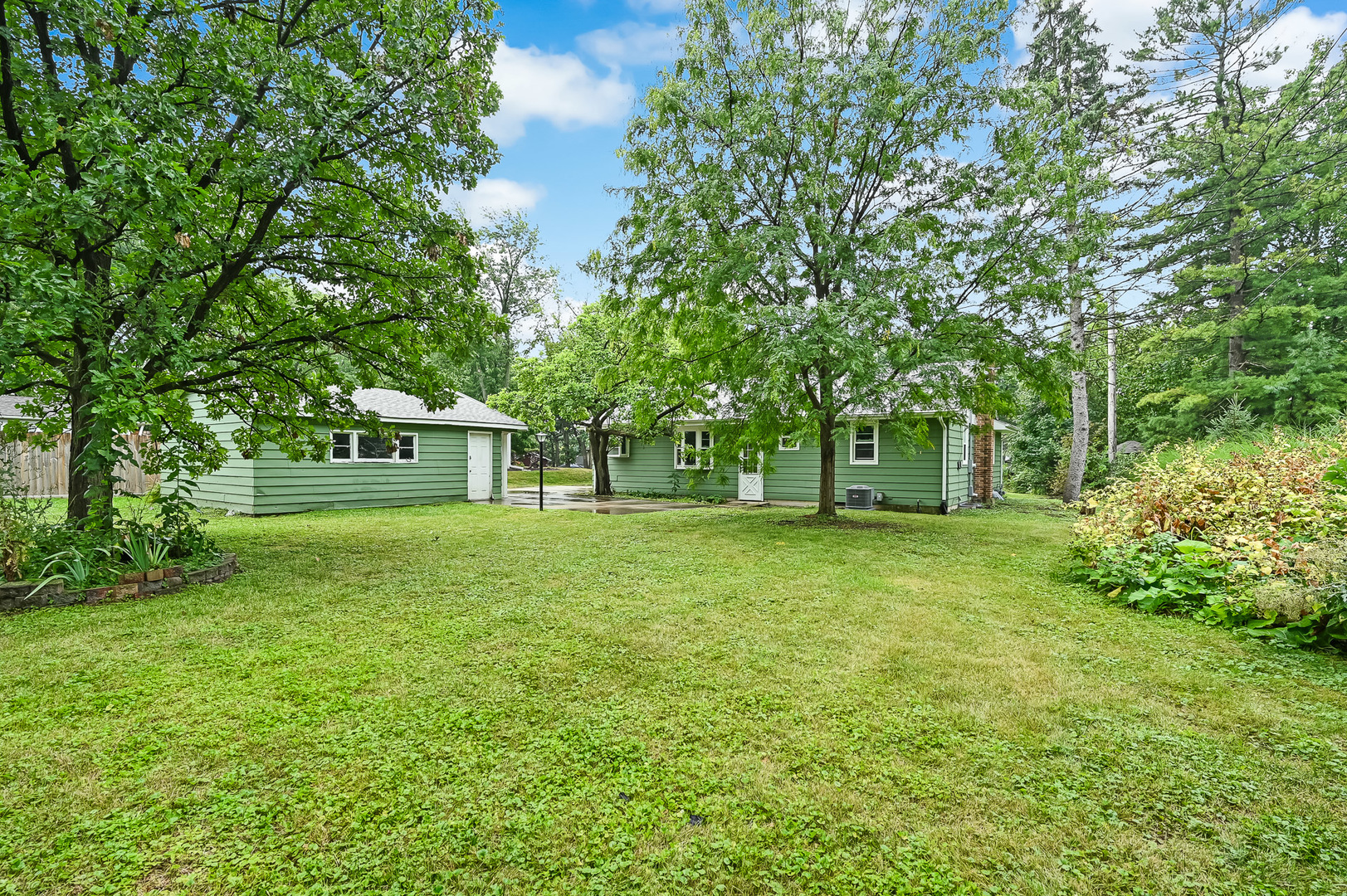 1018 Rolling Drive Lisle, IL 60532 - Photo 5 of 17 a front view of a house with a garden
