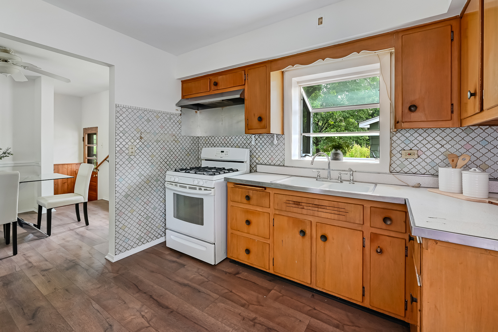 1018 Rolling Drive Lisle, IL 60532 - Photo 10 of 17 a kitchen with stainless steel appliances granite countertop a stove a sink and white cabinets with wooden floors