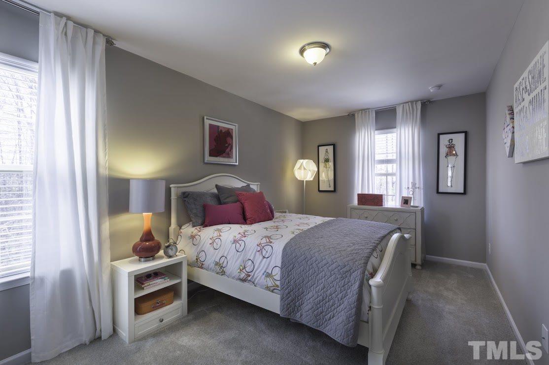 1420 Chatuga Way Raleigh, NC 27610 - Photo 7 of 13 a bedroom with a bed and a window