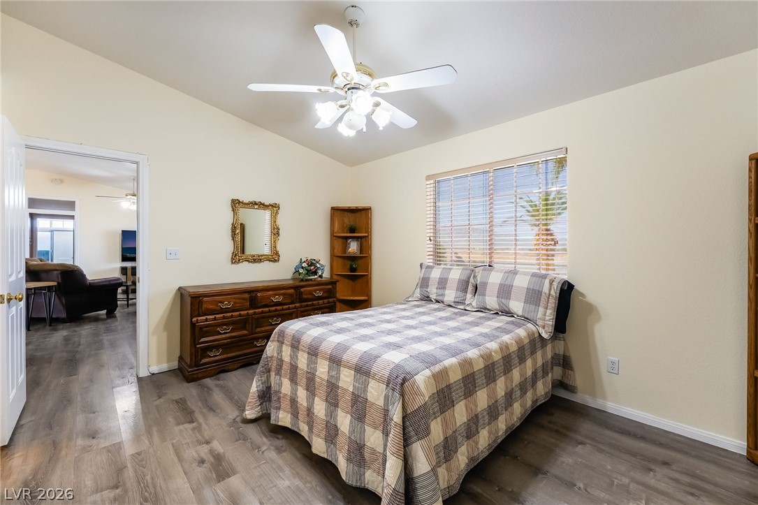 3631 South Blagg Road Pahrump, NV 89048 - Photo 21 of 47 A restful bedroom with vaulted ceilings, wood flooring, and ample natural light invites relaxation.