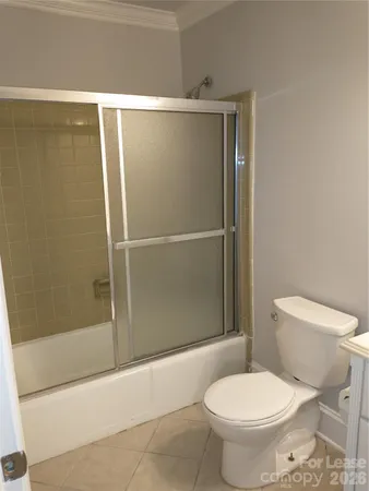 a white toilet sitting next to a bath tub