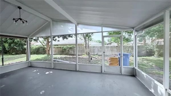 a view of an empty room with windows and balcony