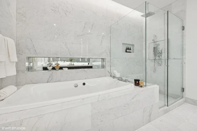 a bathroom with a bathtub and a shower