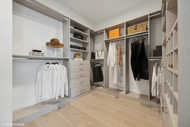 a view of walk in closet with clothes