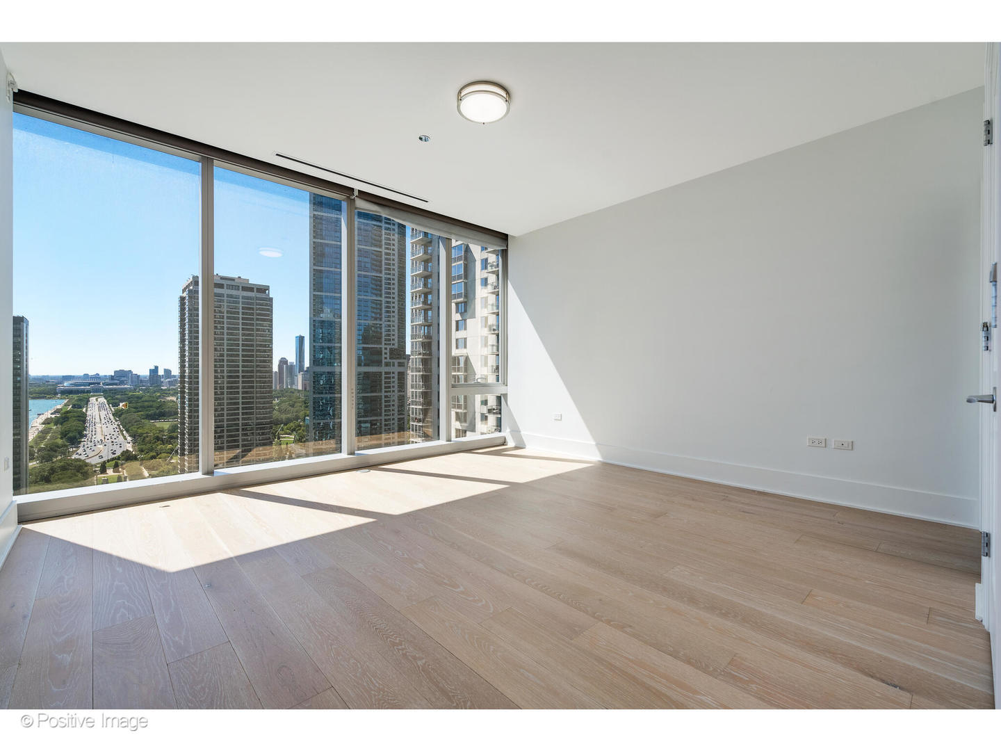 363 East Wacker Drive, Unit 1903 Chicago, IL 60601 - Photo 23 of 39 a view of an empty room with wooden floor and a window