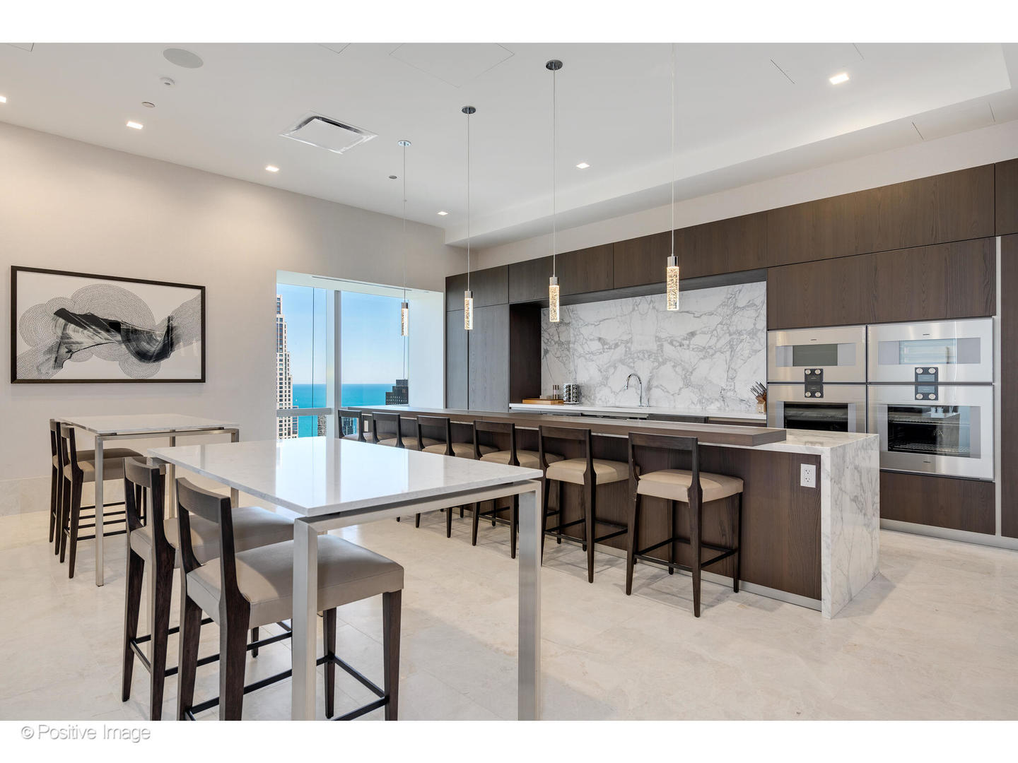 363 East Wacker Drive, Unit 1903 Chicago, IL 60601 - Photo 34 of 39 a kitchen with stainless steel appliances kitchen island granite countertop a dining table chairs and white cabinets