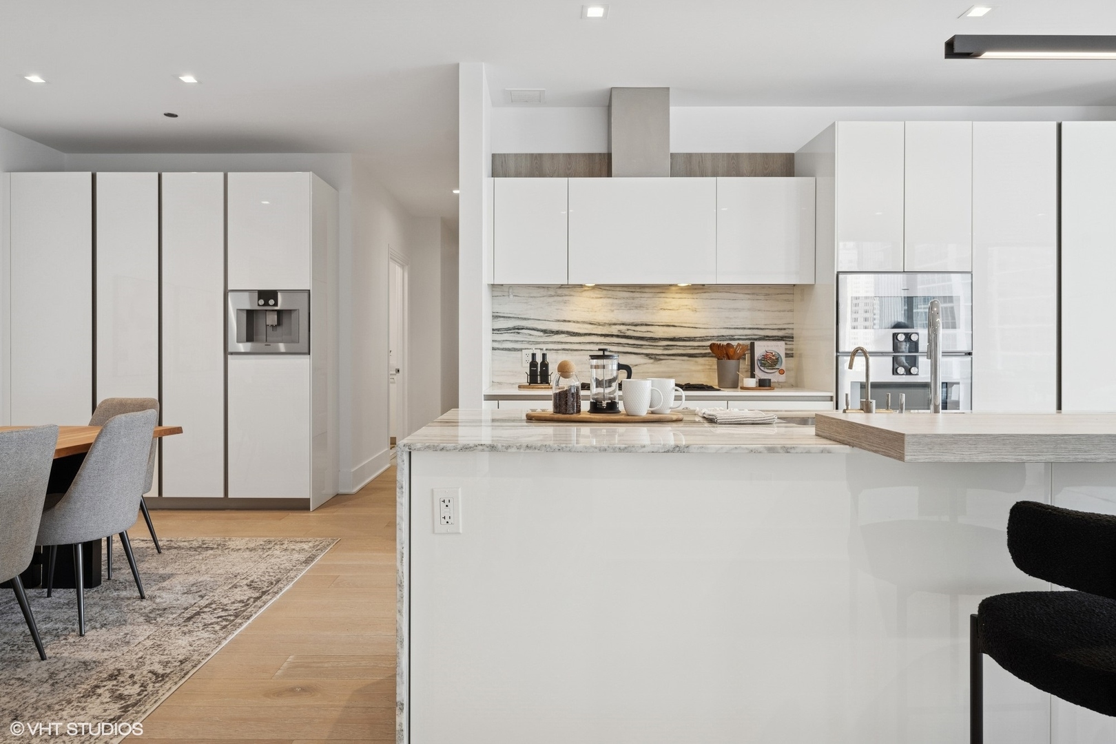 363 East Wacker Drive, Unit 1903 Chicago, IL 60601 - Photo 4 of 39 a kitchen with stainless steel appliances a refrigerator and a stove top oven