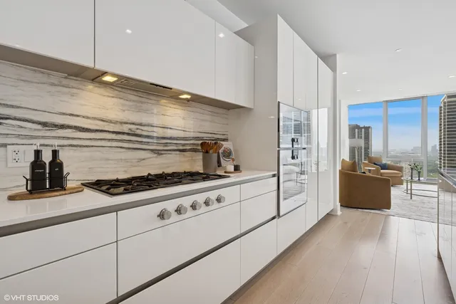 a kitchen with stainless steel appliances granite countertop a stove and a refrigerator