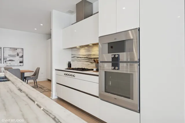 a kitchen with a stove and white cabinets