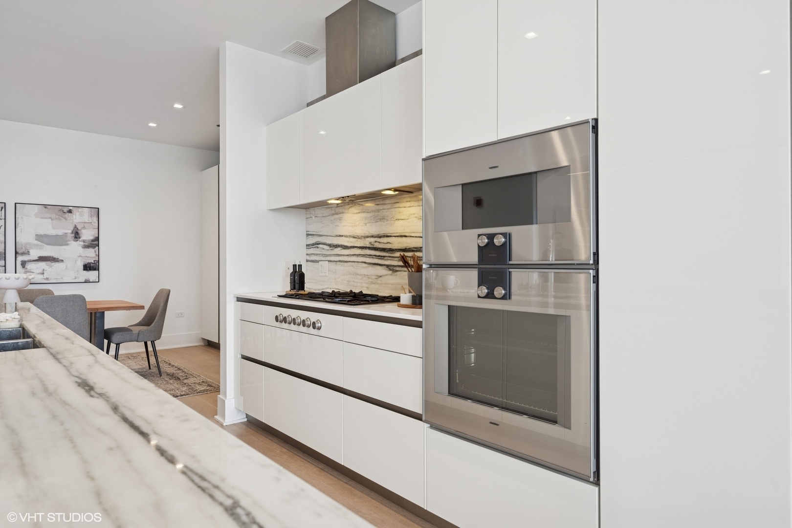 363 East Wacker Drive, Unit 1903 Chicago, IL 60601 - Photo 8 of 39 a kitchen with a stove and white cabinets