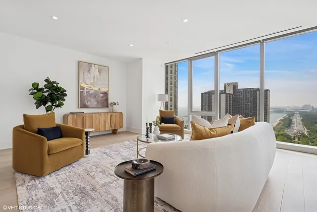 a living room with furniture and a floor to ceiling window