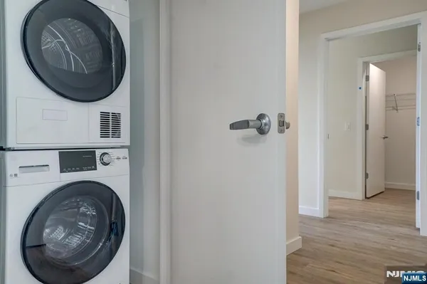 a view of a hallway with washer and dryer