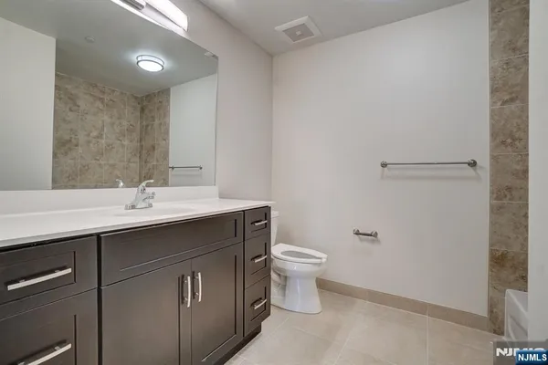 a bathroom with a sink toilet and mirror