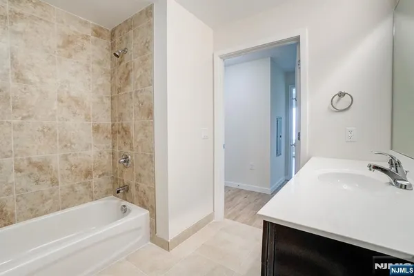 a bathroom with a bathtub and a sink