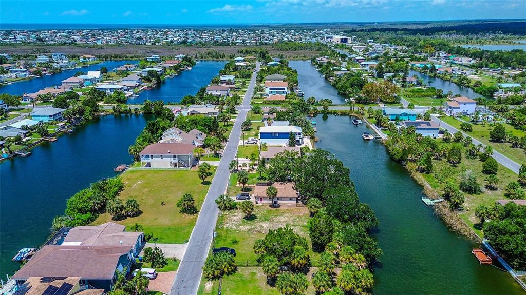 0 Sea Grape Drive, Unit LOT 10 Hernando Beach, FL 34607 - Photo 19 of 23 an aerial view of residential houses with outdoor space and trees