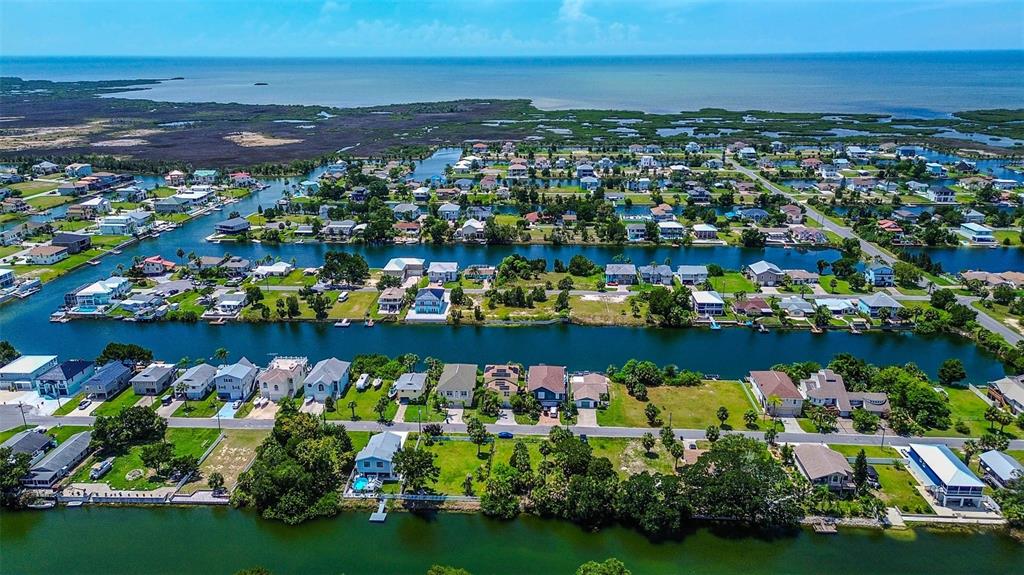 0 Sea Grape Drive, Unit LOT 10 Hernando Beach, FL 34607 - Photo 21 of 23 a view of a lake with a lots of trees and houses