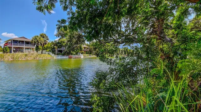 a view of a lake with houses in the back
