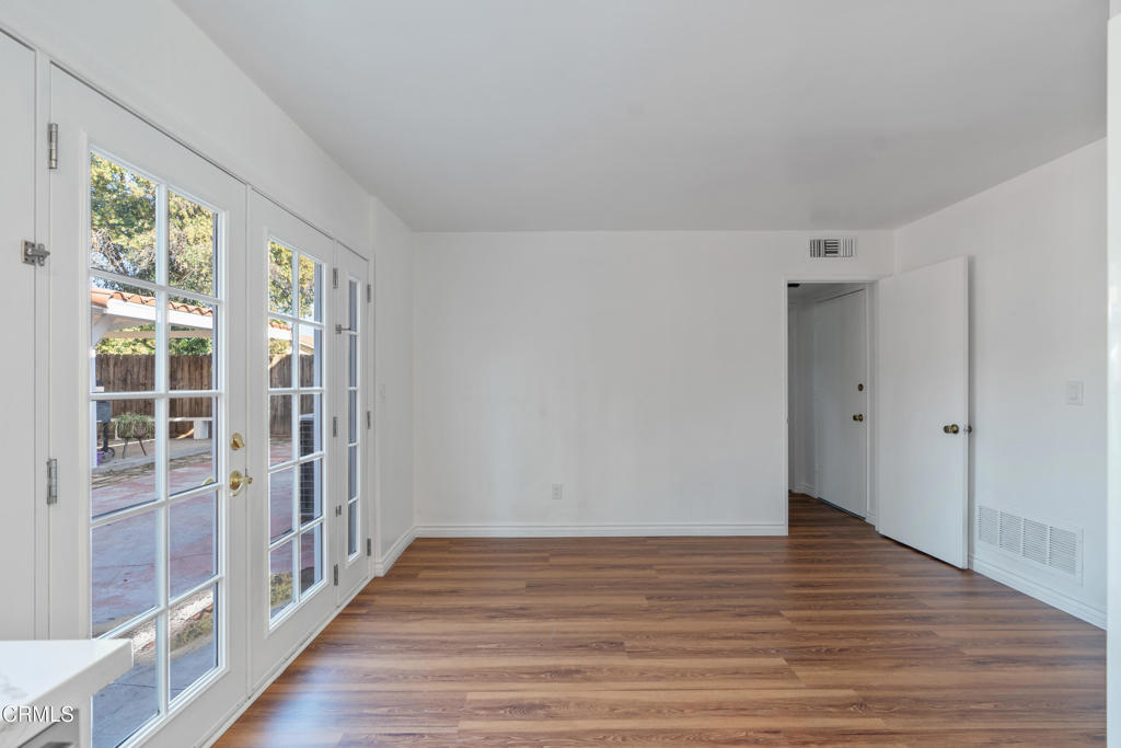 18719 Chase Street Northridge, CA 91324 - Photo 13 of 32 a view of an empty room with wooden floor and windows