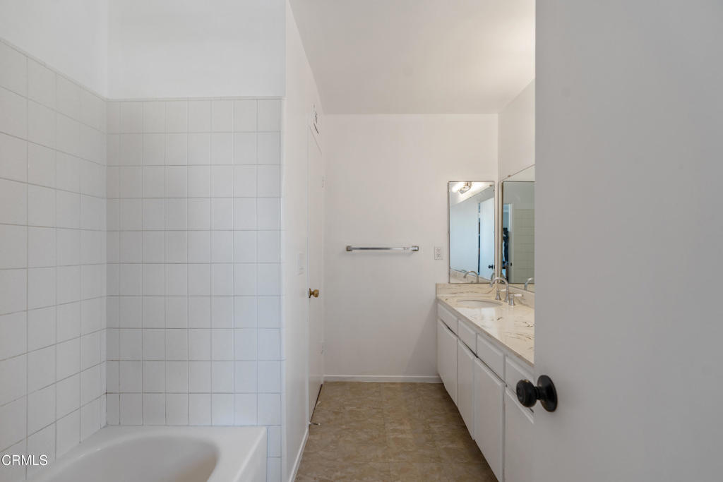 18719 Chase Street Northridge, CA 91324 - Photo 20 of 32 a bathroom with a granite countertop sink a toilet and bathtub