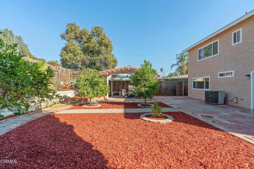 18719 Chase Street Northridge, CA 91324 - Photo 26 of 32 a wooden bench sitting in front of a house