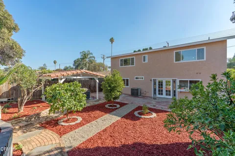 a backyard of a house with yard and outdoor seating