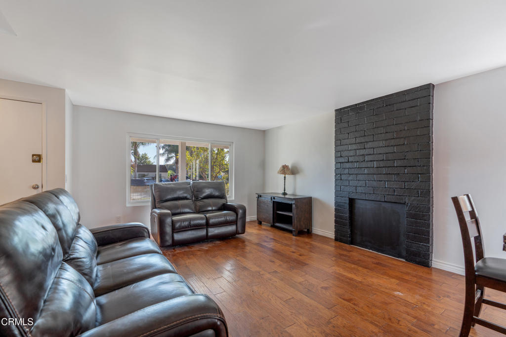 18719 Chase Street Northridge, CA 91324 - Photo 8 of 32 a living room with furniture and a fireplace