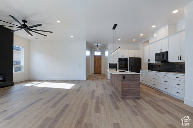 3145 Snow Cyn Road Hurricane, UT 84737 - Photo 37 of 38 Kitchen featuring a ceiling fan, black appliances, light countertops, open floor plan, and tasteful backsplash