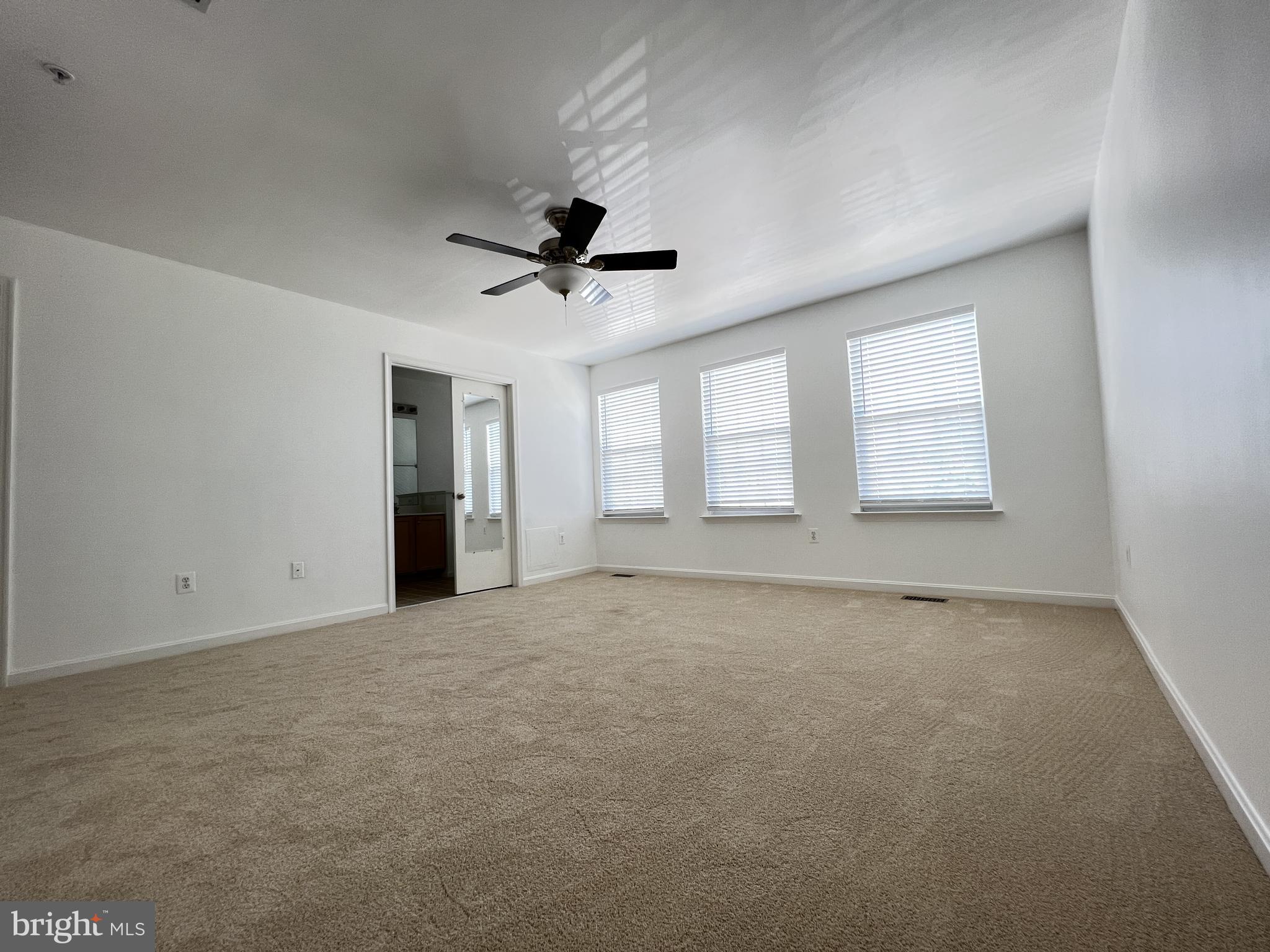 4971 Clarendon Terrace Frederick, MD 21703 - Photo 13 of 35 an empty room with chandelier fan and windows
