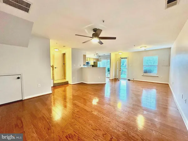 a kitchen with granite countertop a refrigerator and a sink