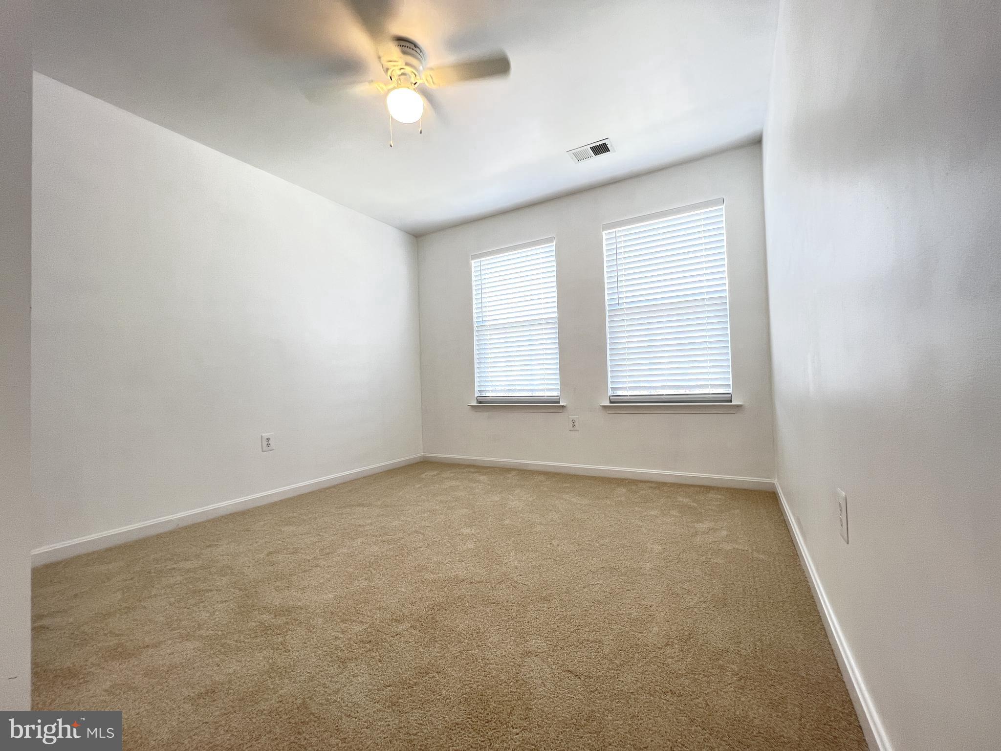 4971 Clarendon Terrace Frederick, MD 21703 - Photo 31 of 35 an empty room with windows and fan