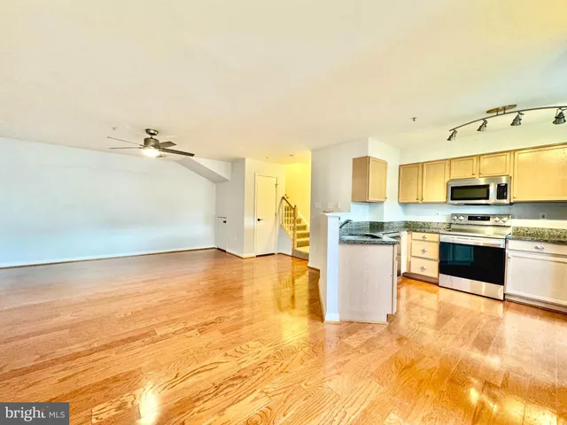 a kitchen with stainless steel appliances granite countertop a stove and a sink