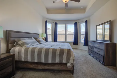 a bed sitting in a bedroom next to a window