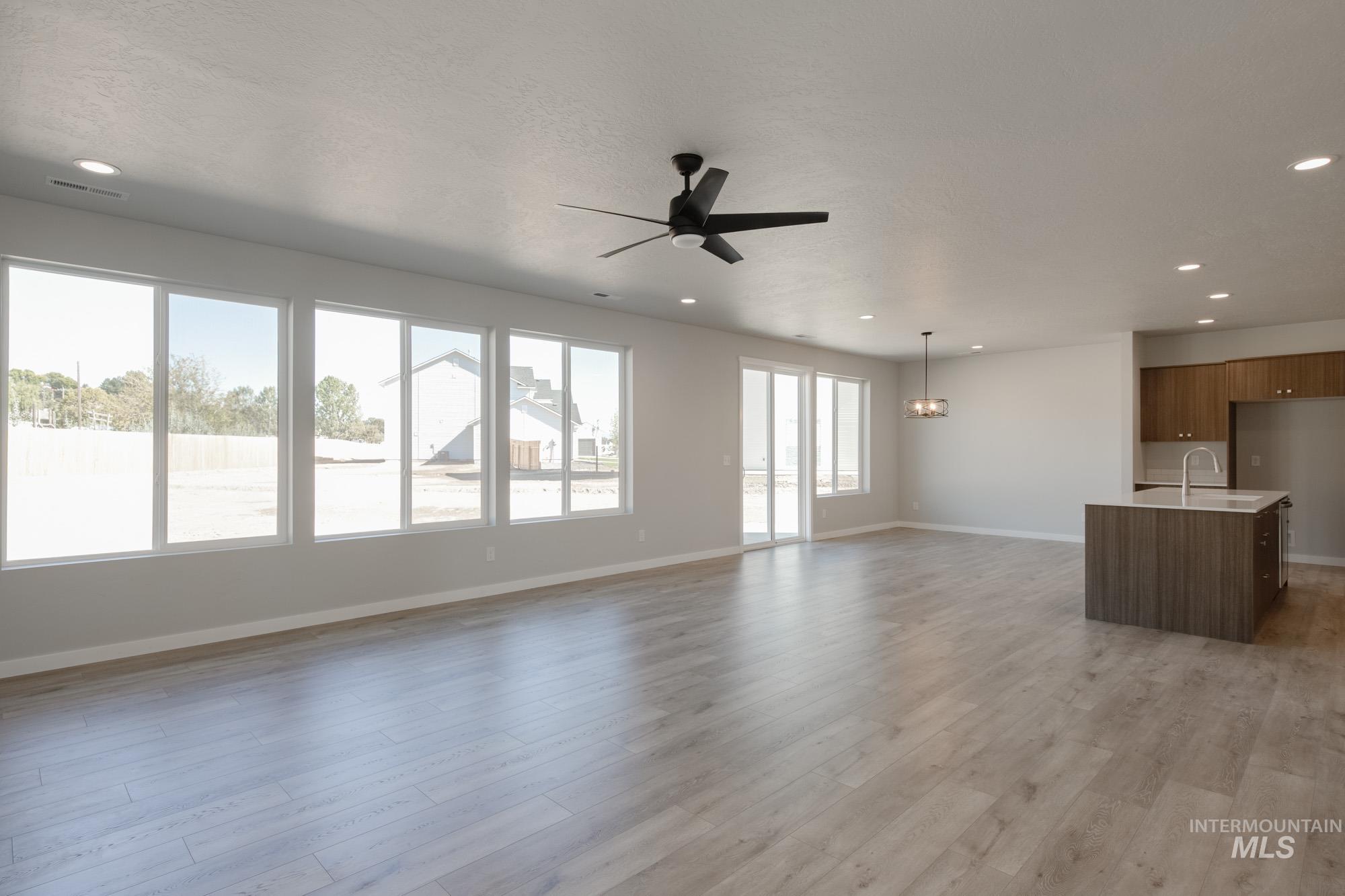 13708 Judson Street Caldwell, ID 83607 - Photo 14 of 32 Unfurnished living room with recessed lighting, light wood-style flooring, and a ceiling fan